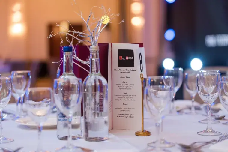 Place setting with glassware and flowers before the gala dinner at the Black Pharma fifth anniversary gala.