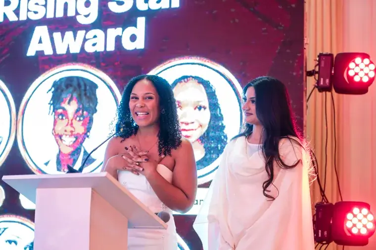 Presenters announcing a winner on the gala stage at the Black Pharma fifth anniversary gala.