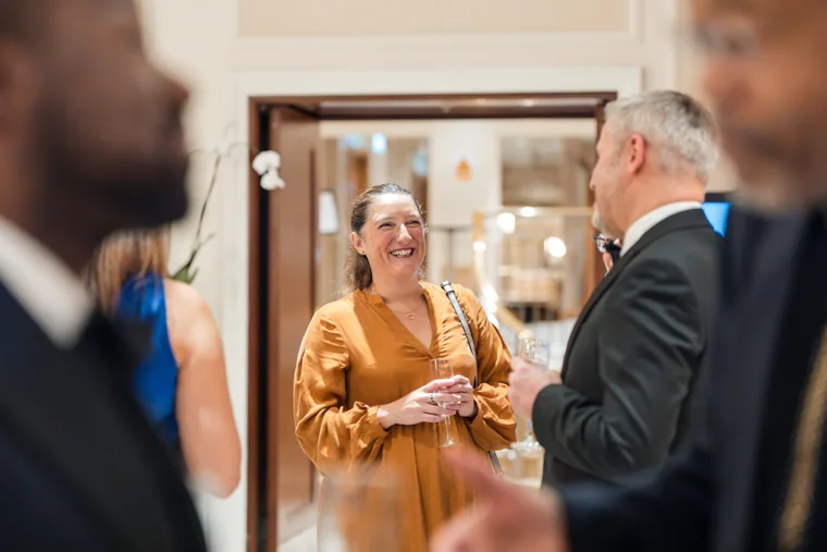 Smiling guests talking during the reception at the Black Pharma fifth anniversary gala.