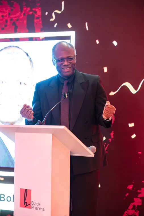 Speaker smiling as he addresses the gala audience at the Black Pharma fifth anniversary gala.