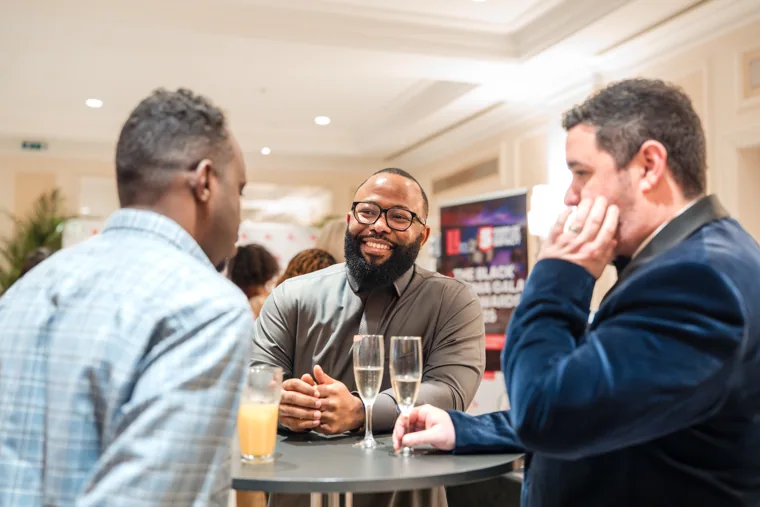 Three guests talking together at the drinks reception at the Black Pharma fifth anniversary gala.