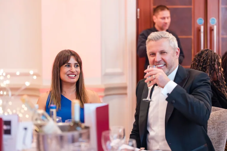 Two guests conversing at a table before the ceremony at the Black Pharma fifth anniversary gala.