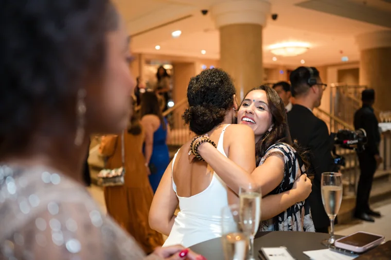 Two guests embracing during the reception at the Black Pharma fifth anniversary gala.