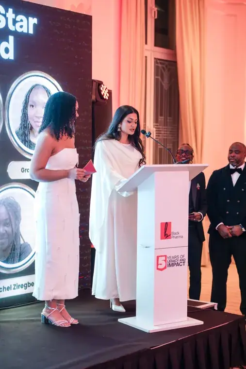 Two presenters at the awards lectern at the Black Pharma fifth anniversary gala.