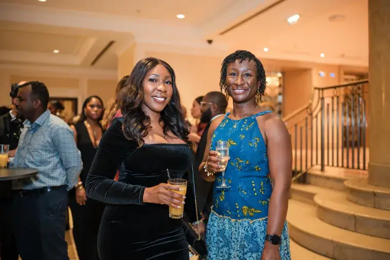 Two women smiling together in the foyer at the Black Pharma fifth anniversary gala.