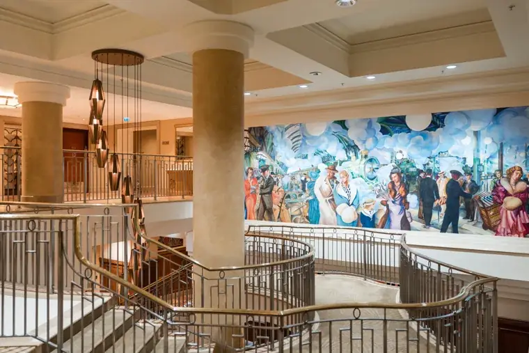 Wide view of the hotel foyer and guests gathering near the staircase at the Black Pharma fifth anniversary gala.