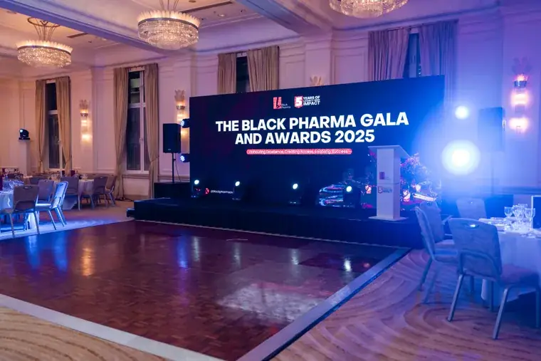 Wide view of the illuminated Black Pharma gala stage at the Black Pharma fifth anniversary gala.