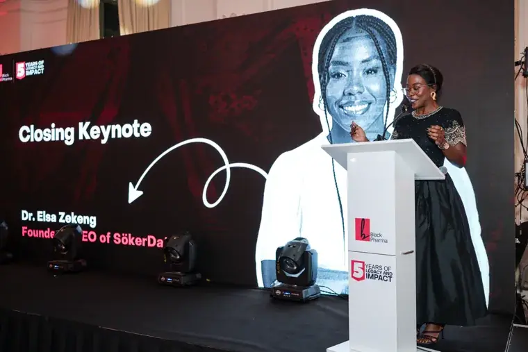 Woman giving the closing keynote at the gala lectern at the Black Pharma fifth anniversary gala.