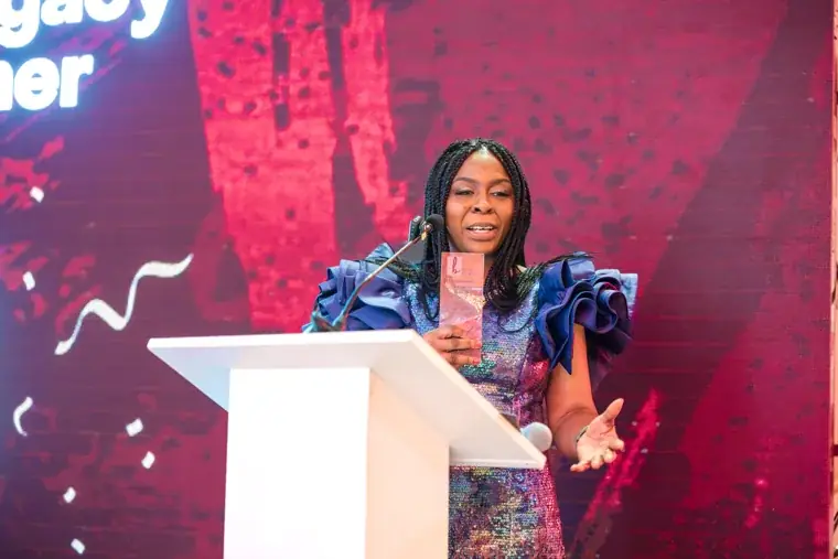 Woman speaking at the Black Pharma anniversary lectern at the Black Pharma fifth anniversary gala.