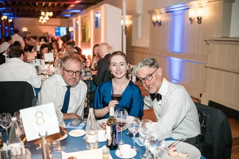 A group of guests posing around their dinner table at the Chambers High Net Worth Awards 2025.