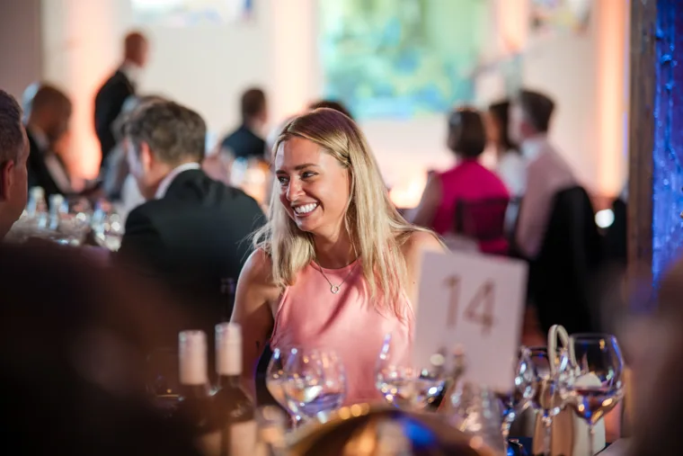 A guest laughing at her table during the dinner at the Chambers High Net Worth Awards 2025.