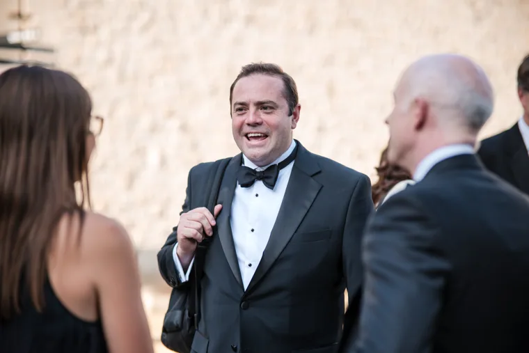 A smiling guest speaking with a small group outdoors at the Chambers High Net Worth Awards 2025.