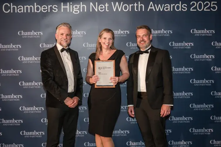Award recipients holding a certificate at the branded photo wall at the Chambers High Net Worth Awards 2025.
