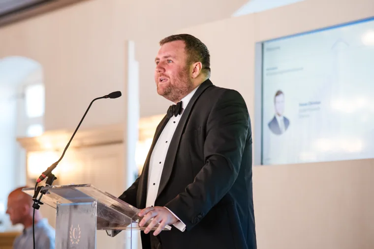 Close view of a speaker addressing guests from the lectern at the Chambers High Net Worth Awards 2025.