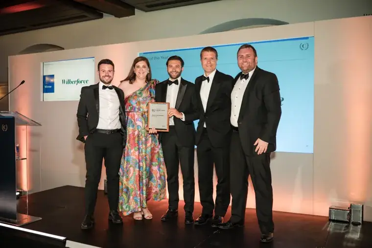 Five award recipients posing together on stage at the Chambers High Net Worth Awards 2025.