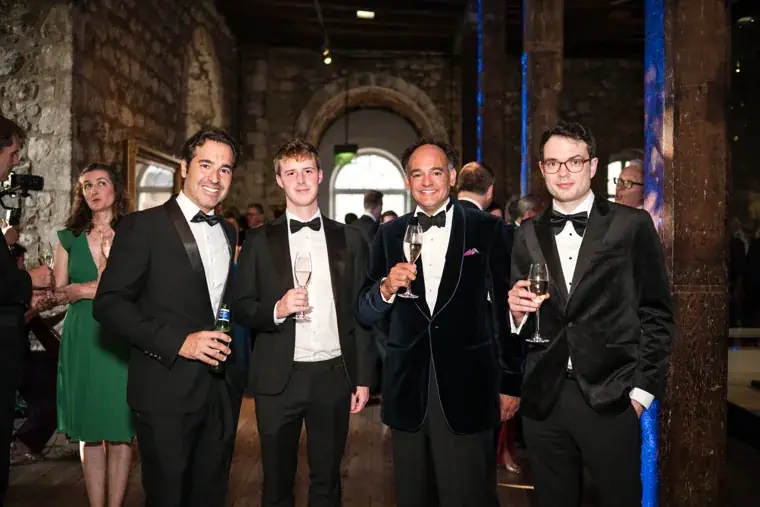 Five guests posing together at the reception at the Chambers High Net Worth Awards 2025.