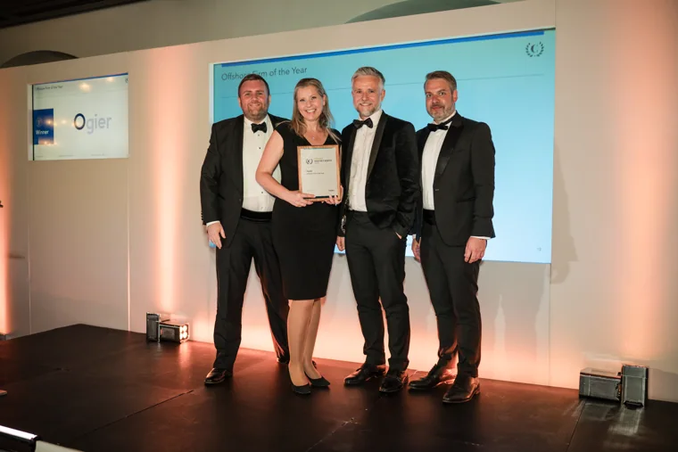 Four award recipients posing with their certificate on stage at the Chambers High Net Worth Awards 2025.
