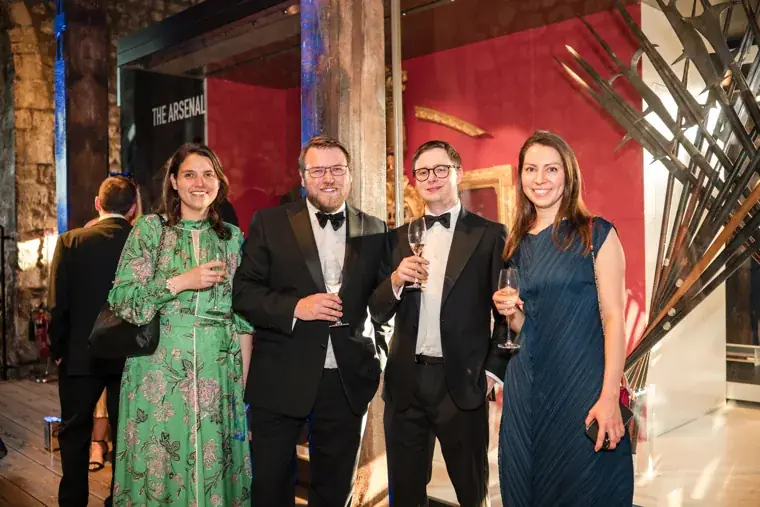 Four guests posing in front of a red display at the Chambers High Net Worth Awards 2025.