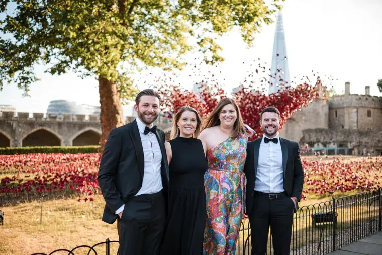 Four guests posing together in the Tower grounds at the Chambers High Net Worth Awards 2025.