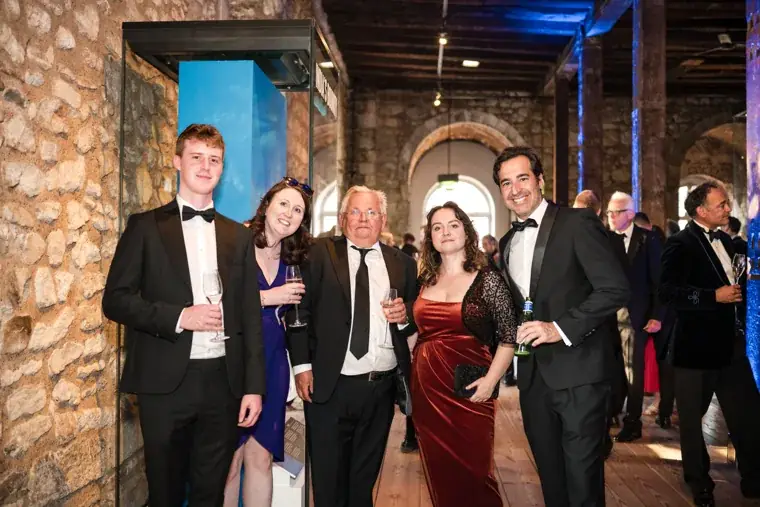 Guests posing together among the exhibition displays at the Chambers High Net Worth Awards 2025.