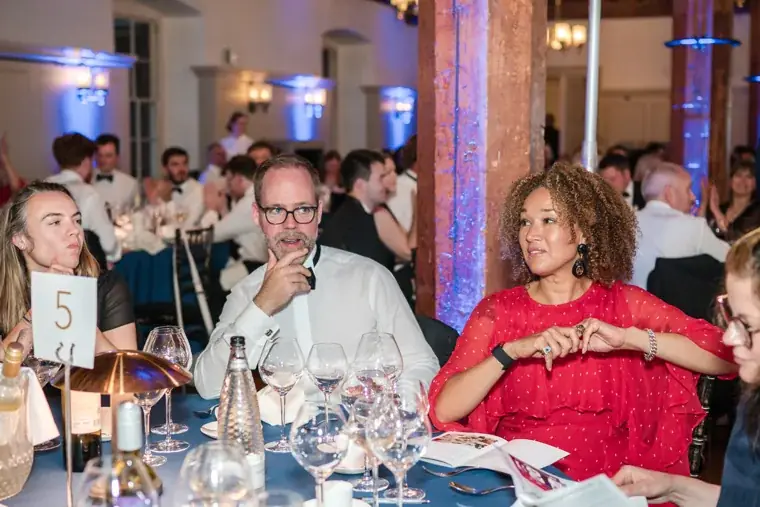Guests seated around a dinner table watching the ceremony at the Chambers High Net Worth Awards 2025.