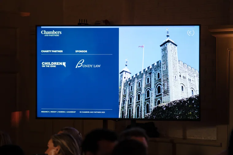 The event presentation screen displaying Chambers branding and the Tower of London at the Chambers High Net Worth Awards 2025.