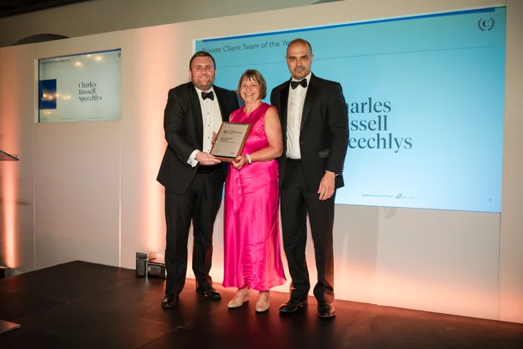 Three award recipients posing with their certificate on stage at the Chambers High Net Worth Awards 2025.