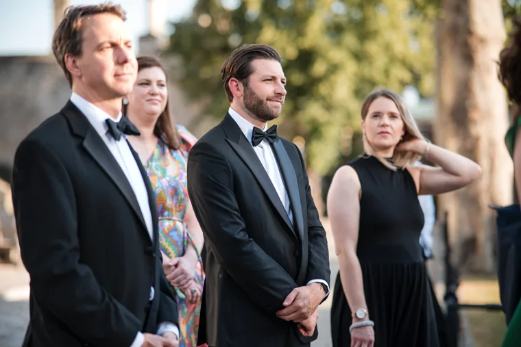 Three guests listening together during the outdoor reception at the Chambers High Net Worth Awards 2025.