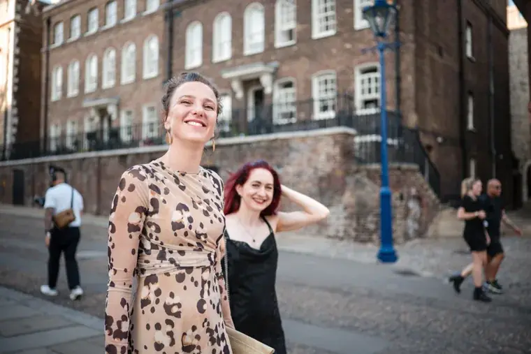 Two guests smiling during an outdoor conversation at the Chambers High Net Worth Awards 2025.