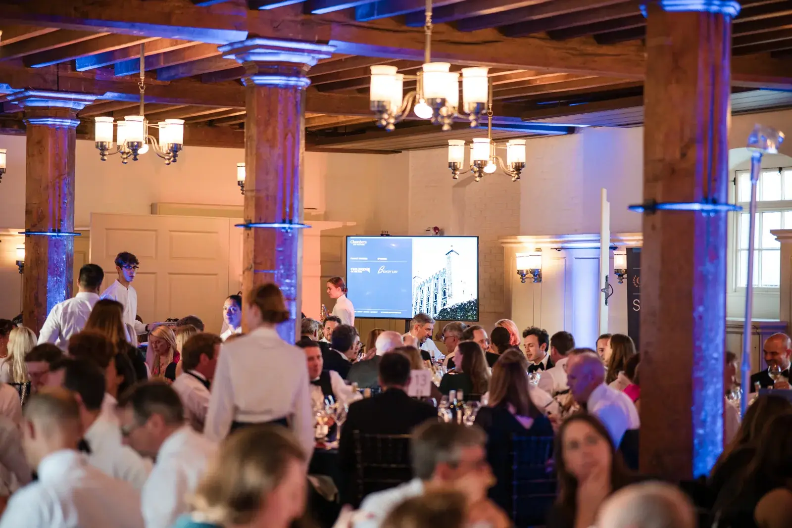 Wide view of guests seated beneath the timber beams for the awards dinner at the Chambers High Net Worth Awards 2025.