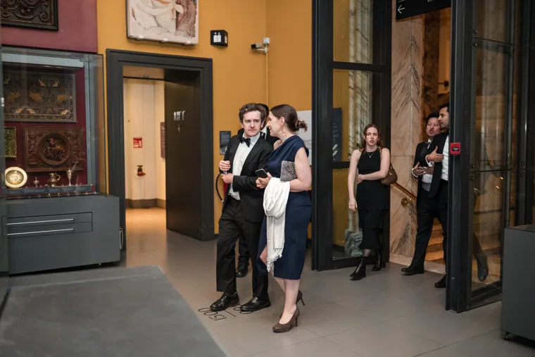 A group entering the gallery in evening dress at the Chambers UK Awards winter edition.