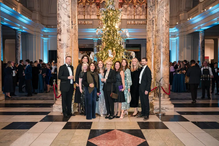 A group posing beneath the decorated tree at the Chambers UK Awards winter edition.