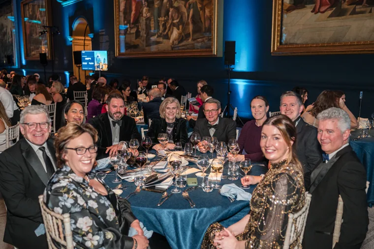 A group posing together at their table at the Chambers UK Awards winter edition.