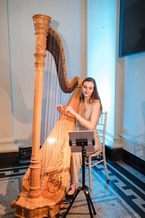 A harpist performing in the reception room at the Chambers UK Awards winter edition.