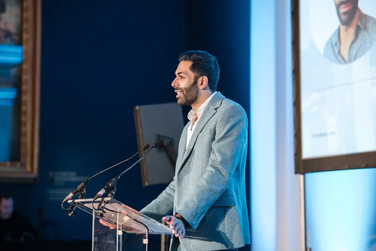 A man speaking on the awards stage at the Chambers UK Awards winter edition.