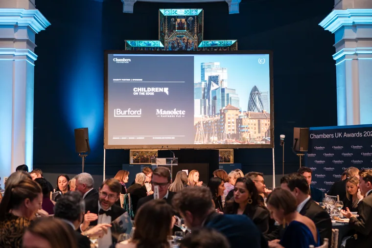 A presentation screen beside the dinner tables at the Chambers UK Awards winter edition.
