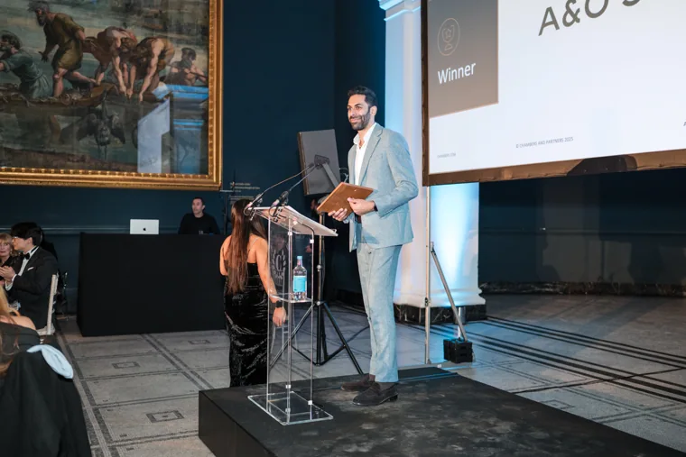 A presenter speaking at the lectern at the Chambers UK Awards winter edition.