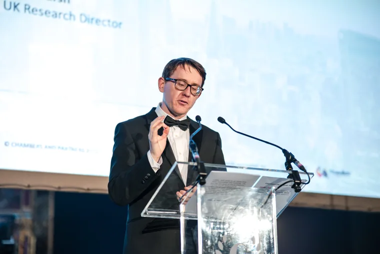 A speaker gesturing during the presentation at the Chambers UK Awards winter edition.
