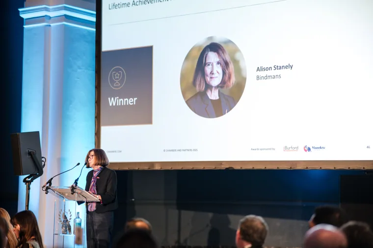 A winner announcement projected above the stage at the Chambers UK Awards winter edition.