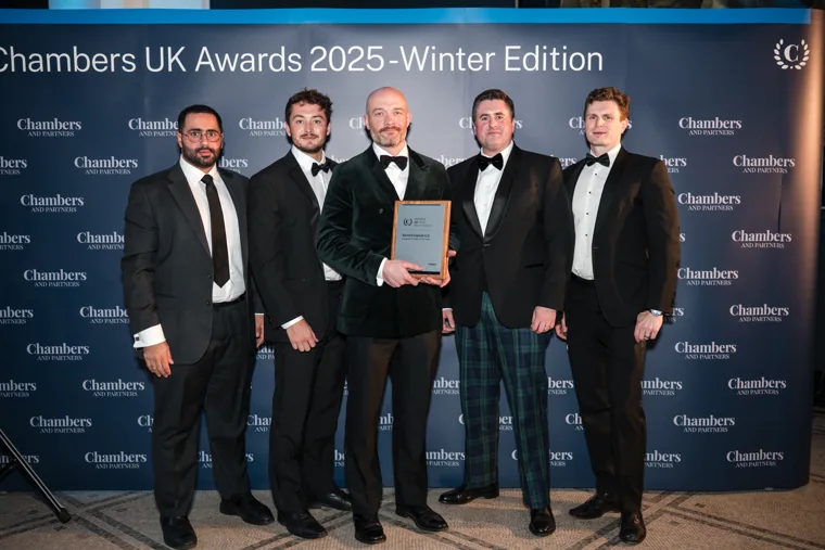 A winning team posing with its certificate at the Chambers UK Awards winter edition.