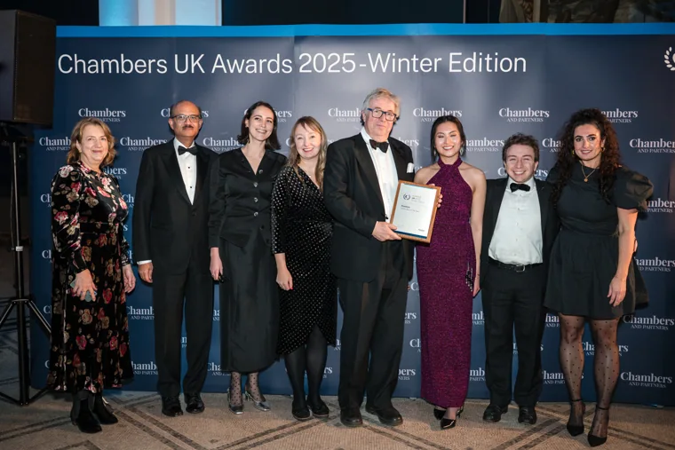 A winning team posing with its framed certificate at the Chambers UK Awards winter edition.