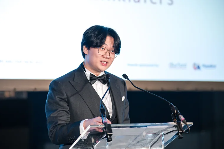 An award recipient speaking at the lectern at the Chambers UK Awards winter edition.
