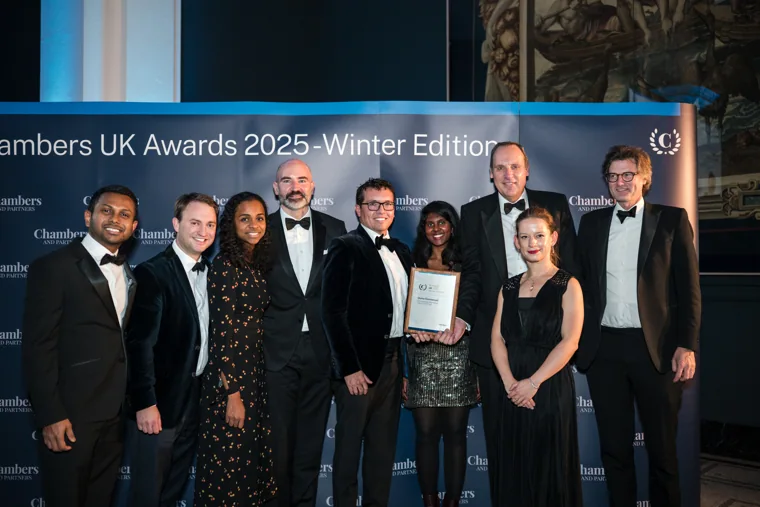 An awards team posing against the Chambers backdrop at the Chambers UK Awards winter edition.