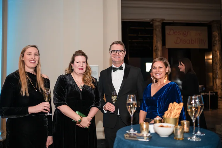 Four guests posing beside the drinks reception at the Chambers UK Awards winter edition.