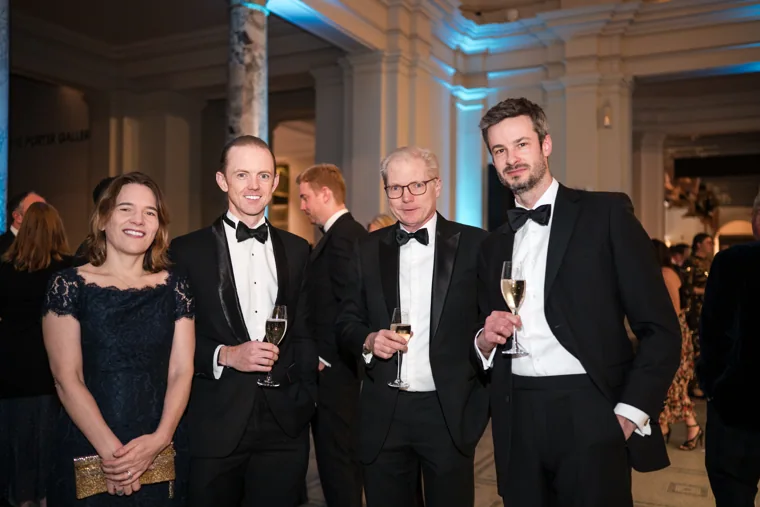 Four guests posing together with drinks at the Chambers UK Awards winter edition.