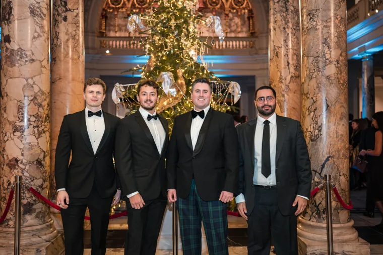 Four men posing beneath the decorated tree at the Chambers UK Awards winter edition.