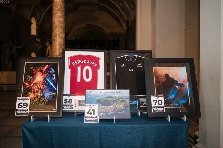 Silent auction prizes arranged on a table at the Chambers UK Awards winter edition.