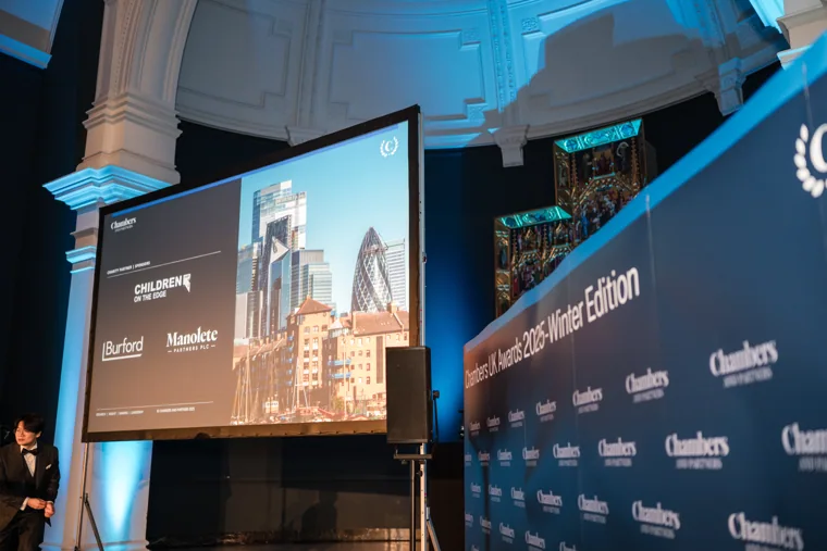 The awards presentation screen beside the stage at the Chambers UK Awards winter edition.