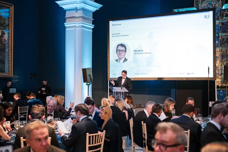 The awards speaker on screen above the audience at the Chambers UK Awards winter edition.