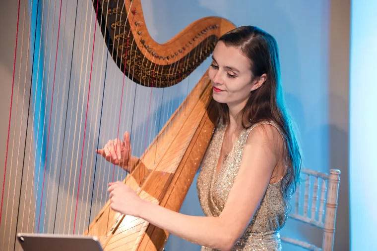 The harpist smiling during her performance at the Chambers UK Awards winter edition.